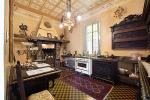 a kitchen with a stove and a sink in it at Historic Villa Argegno Como lake in Dizzasco