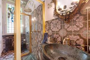 a bathroom with a large tub and a mirror at Historic Villa Argegno Como lake in Dizzasco +34 photos