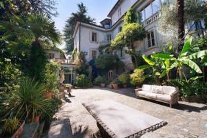 a house with a couch in front of it at Historic Villa Argegno Como lake in Dizzasco