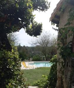 a view of a swimming pool from a yard at Gite Terre Happy Ribérac in Ribérac