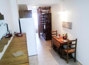 a kitchen and dining room with a table and chairs at Gite Terre Happy Ribérac in Ribérac