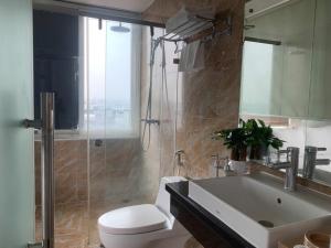 a bathroom with a sink and a toilet and a shower at Hanoi Central Westlake Hotel in Hanoi