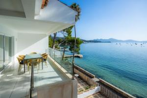 a house with a balcony with a view of the water at Catalina 3b in Port de Pollensa