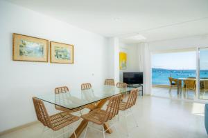 a dining room with a glass table and chairs at Catalina 3b in Port de Pollensa
