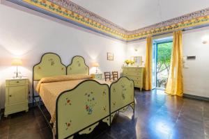 a bedroom with a green bed and a window at Villa Aguglie Con Piscina in Modica +112 photos