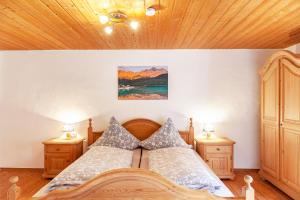 a bedroom with a bed and two night stands at Haus Niklos - Waldeck in Grainau