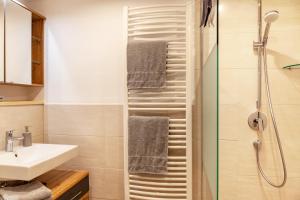 a bathroom with a sink and a shower at Haus Niklos - Waldeck in Grainau +21 photos