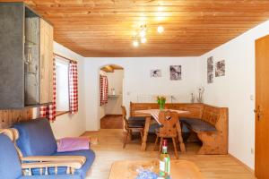 a living room with a table and a dining room at Haus Niklos - Waldeck in Grainau