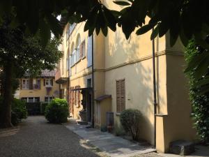 a white building with a street in front of it at in Villa Belli in Miasino