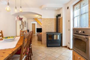 a kitchen and dining room with a table and a stove at Maso Gigi in Castel Ivano