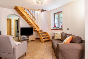 a living room with a couch and a tv at Maso Gigi in Castel Ivano
