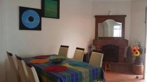 a dining room with a table and chairs and a fireplace at House pc in Porto da Cruz
