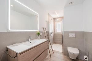 a bathroom with a sink and a toilet at Villa Abril in Santanyi +23 photos