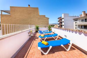 a row of blue lounge chairs on a roof at Albercutx Pollentia 3 in Pollença