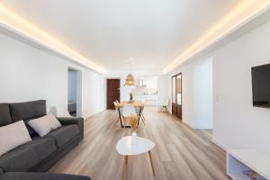 a living room with a couch and a table at Albercutx Pollentia 3 in Pollença
