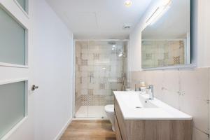 a bathroom with a sink and a toilet and a mirror at Albercutx Pollentia 3 in Pollença +18 photos