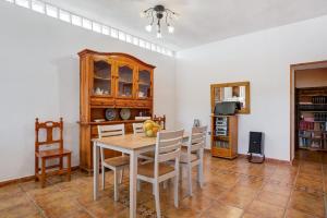 a dining room with a table and chairs at Los Olivos in Barbate