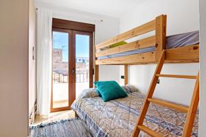 a bedroom with a bunk bed and a ladder at Somni in Jávea