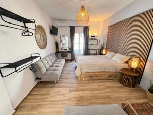 a bedroom with a bed and a couch at aeolian blu 1 in Parikia