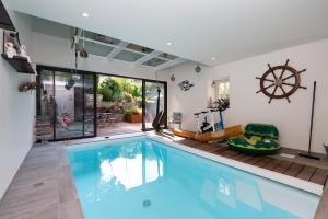 a swimming pool in a house at Ty Al Louarn - Piscine - Spa in Brech