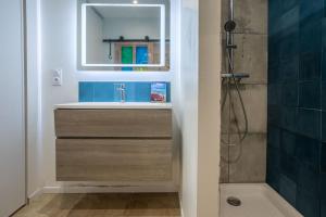 a bathroom with a sink and a mirror and a shower at Maison de charme avec jacuzzi in Lorgues +26 photos