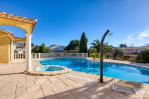 a swimming pool with a gazebo at La Madrague St Vincent Apt A in Le Grau-dʼAgde