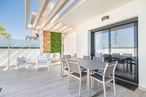 a dining room with a table and chairs at Belle in Orihuela Costa