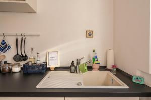 a kitchen counter with a white sink in a kitchen at Fewo Sankt Johann ll in Konstanz +20 photos