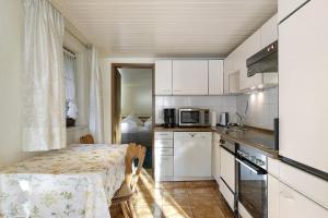a small kitchen with a table and a microwave at Haus Steinhäusle - 2 fewos in Vöhrenbach