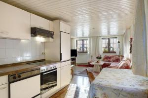 a kitchen with white cabinets and a table in a room at Haus Steinhäusle - 2 fewos in Vöhrenbach +21 photos