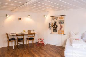 a room with a table and chairs and a bed at Fewo Sankt Johann ll in Konstanz