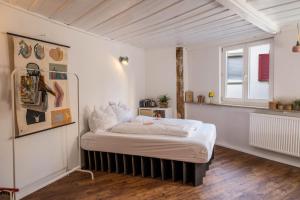a bedroom with a bed in the corner of a room at Fewo Sankt Johann ll in Konstanz