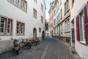 a group of bikes parked on a street next to buildings at Fewo Sankt Johann ll in Konstanz
