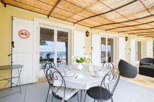 a table and chairs on a patio with a view of the ocean at Maison avec Piscine in Tourrettes