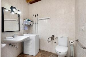 a white bathroom with a toilet and a sink at Guenia I in Teguise +7 photos