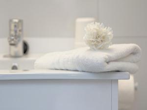 a pile of towels sitting on a bathroom counter at Casa Convent in Alcudia +21 photos