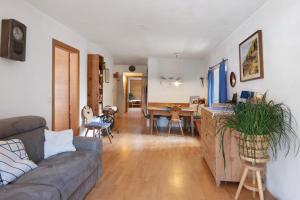 a living room with a couch and a dining room at Bachguthof in Silandro