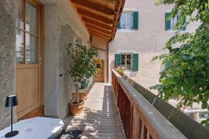 a porch of a house with a door and plants at Bachguthof in Silandro