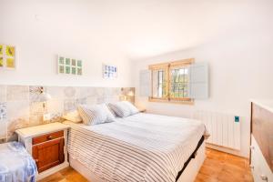 a bedroom with a large bed in a room at Can Favo in Copóns +26 photos