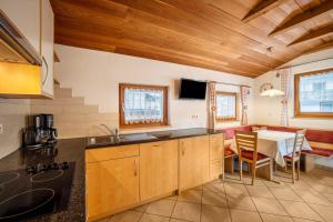 a kitchen with a table and a dining room at Speckign Apartment 3 in Cadipietra
