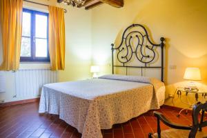 a bedroom with a large bed and a window at Il Cancellone - Grillo in Montiano +14 photos