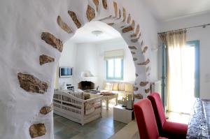 an archway in a living room with a couch and a table at Villa St' Astra in Koufonisia