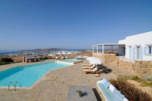 a villa with a swimming pool and a house at Villa St' Astra in Koufonisia