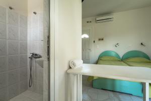 a bathroom with a shower and a bed at Angela partial sea view 6 in Kefallonia