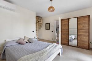 a bedroom with a bed and a sliding glass door at Agriturismo Per Caso in Carignano