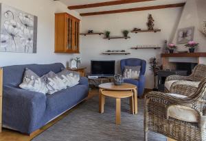 a living room with a blue couch and a table at Vista Bahía in Moraira