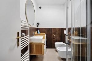 a bathroom with a sink and a toilet and a mirror at Agriturismo Per Caso in Carignano +52 photos