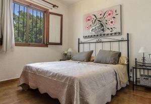 a bedroom with a bed and a window at Vista Bahía in Moraira +13 photos