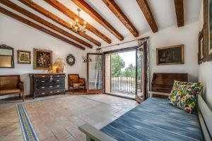 a living room with a couch and a window at Finca Can Moleta in Cala Mendia +31 photos