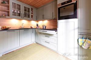 a white kitchen with white cabinets and a microwave at Ferienwohnung Bienennest in Mittenwald